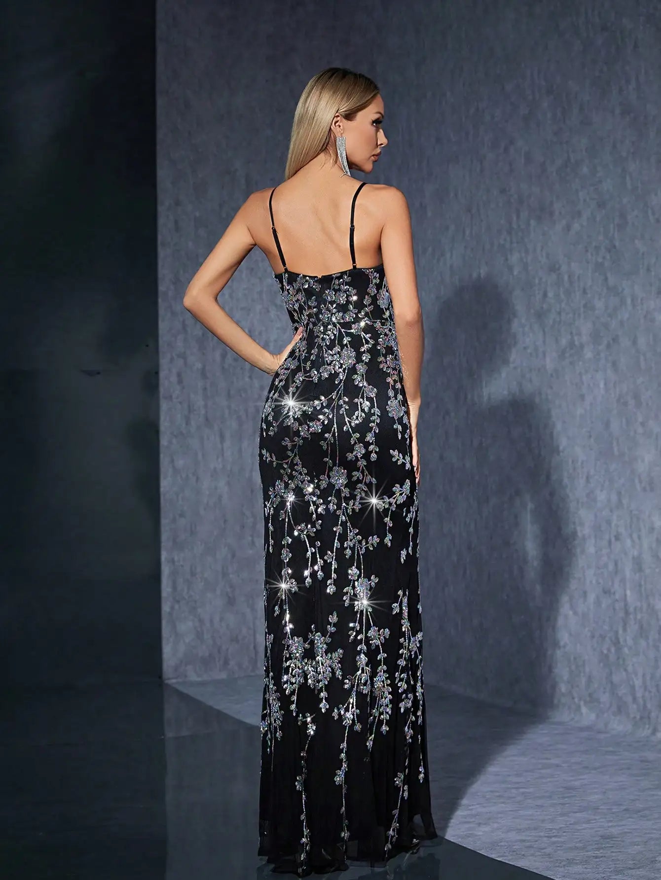 Back view of formal black sequin gown with zipper and long hem
