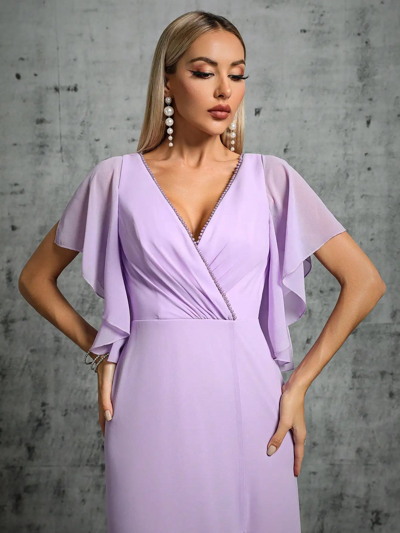 Lilac wedding guest dress with flutter sleeves and thigh-high slit
