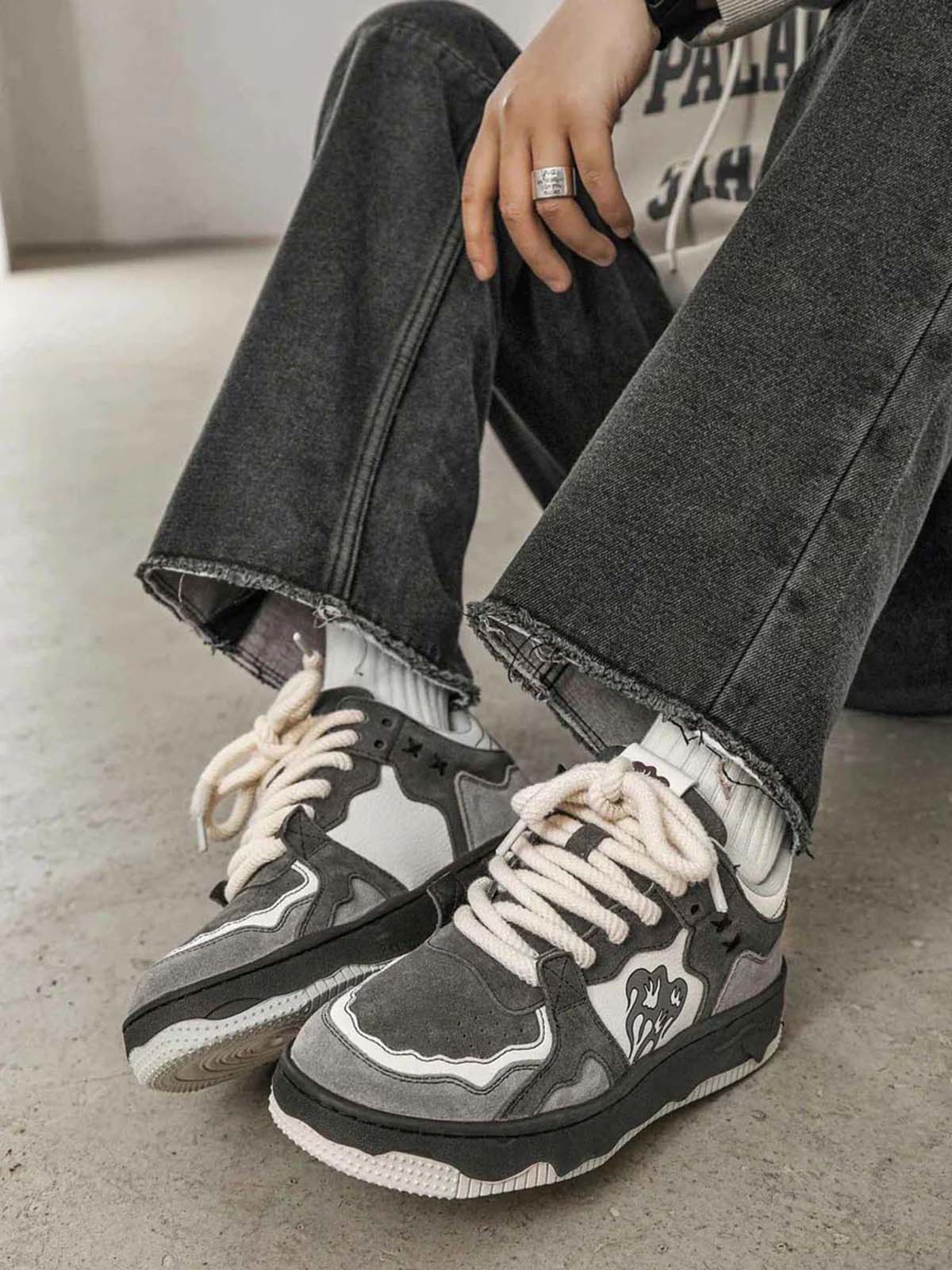 Men’s grey suede chunky sneakers displayed on table
