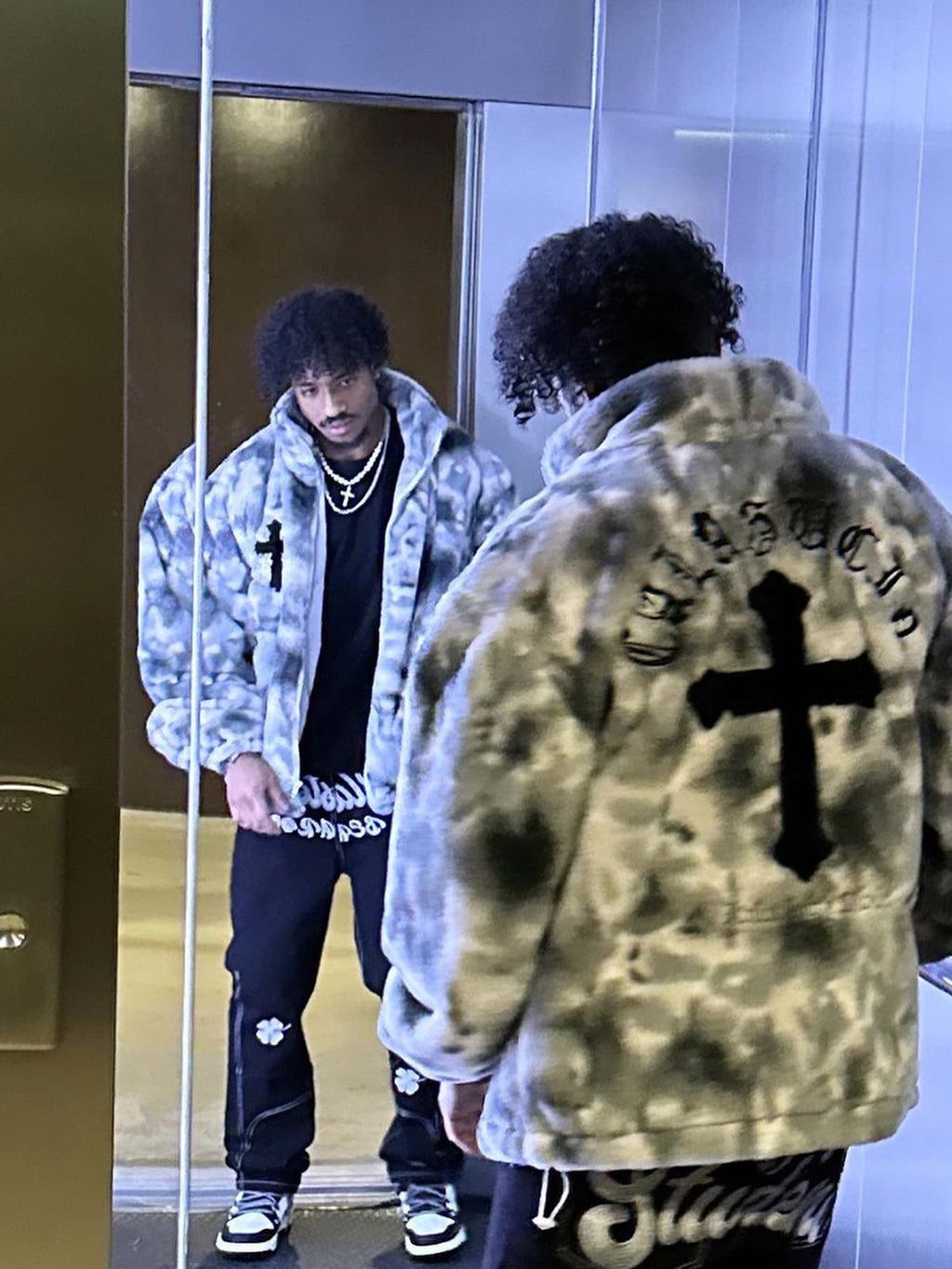 Close-up texture of men’s grey tie-dye faux fur jacket