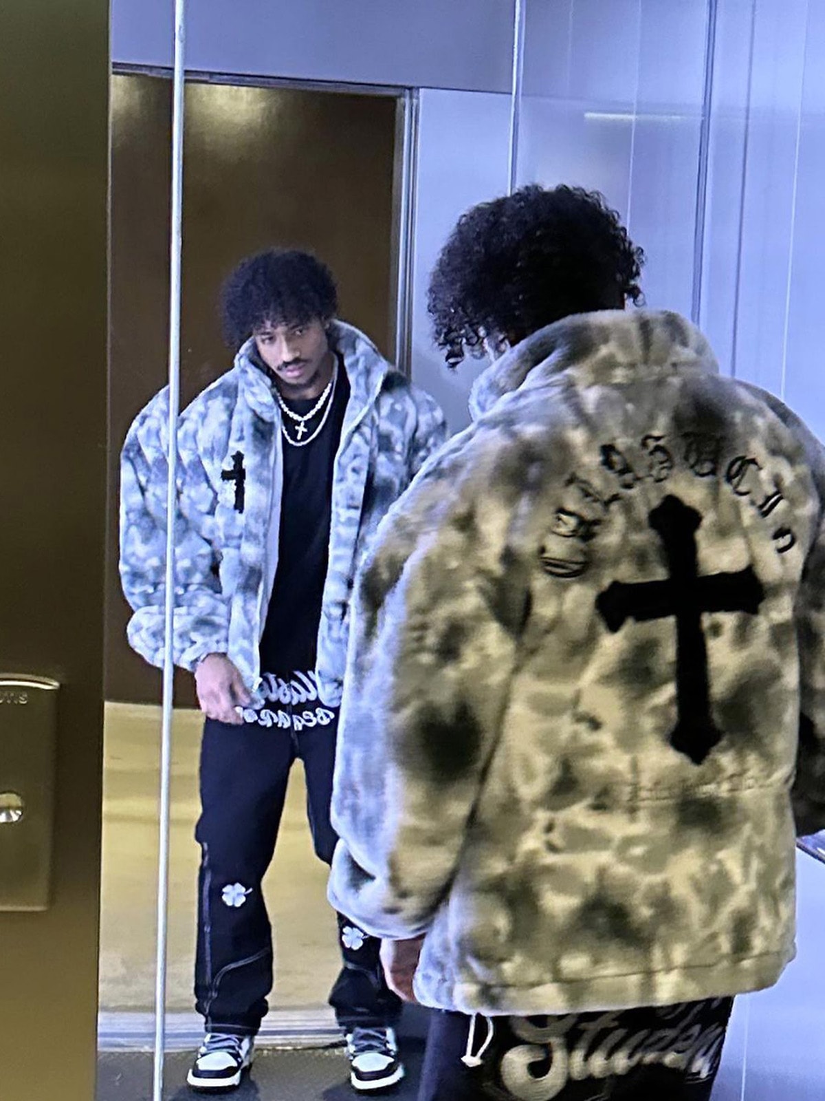 Close-up texture of men’s grey tie-dye faux fur jacket