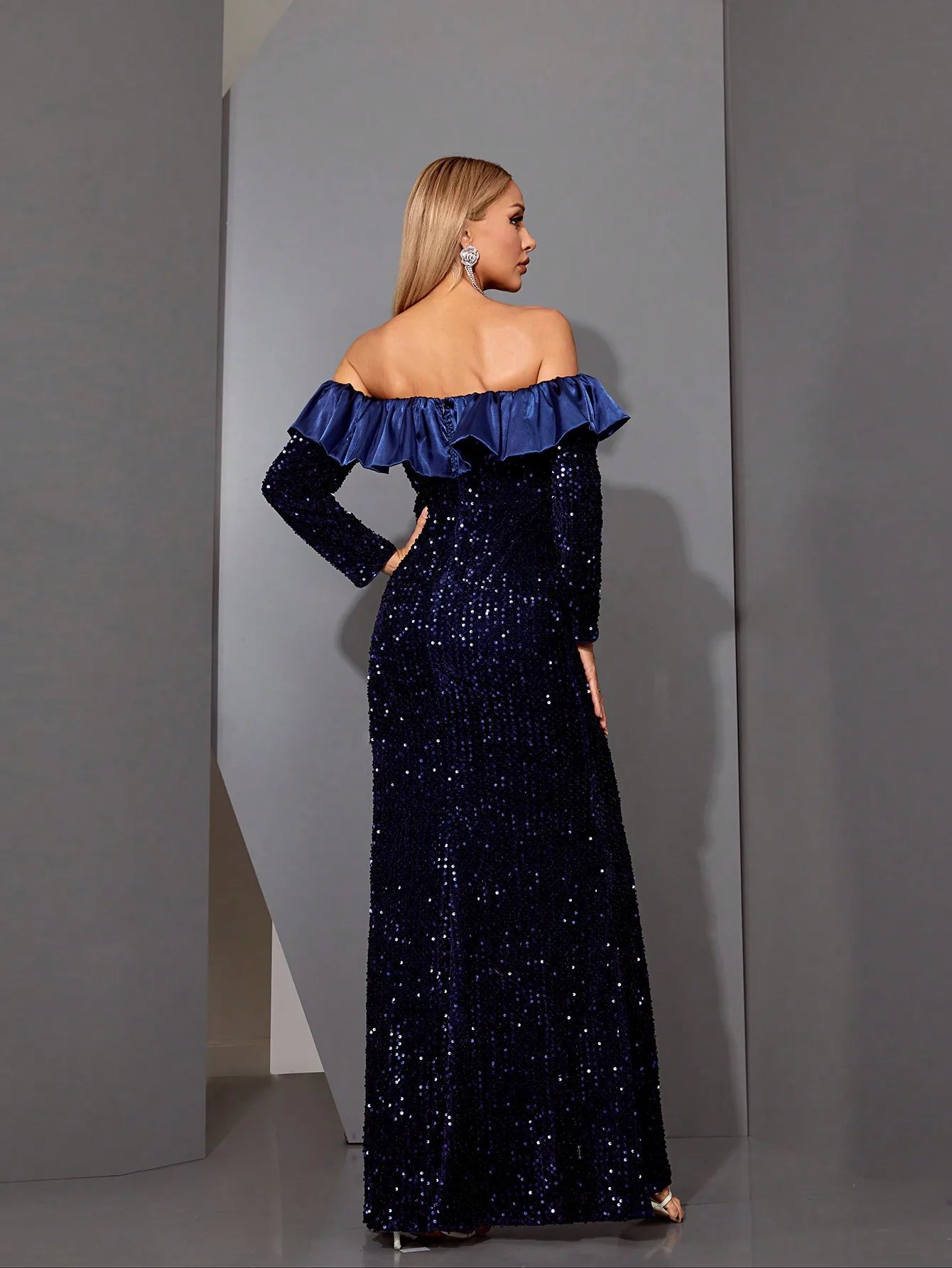 Back view of navy formal gown with fitted silhouette and zipper closure

