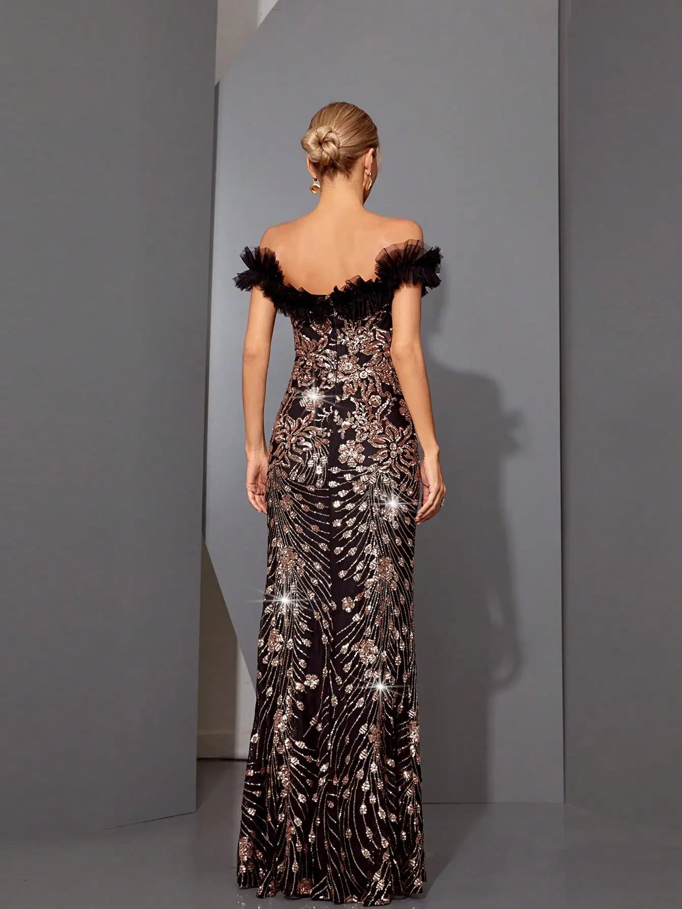 Back view of black sequin fishtail gown with concealed zipper
