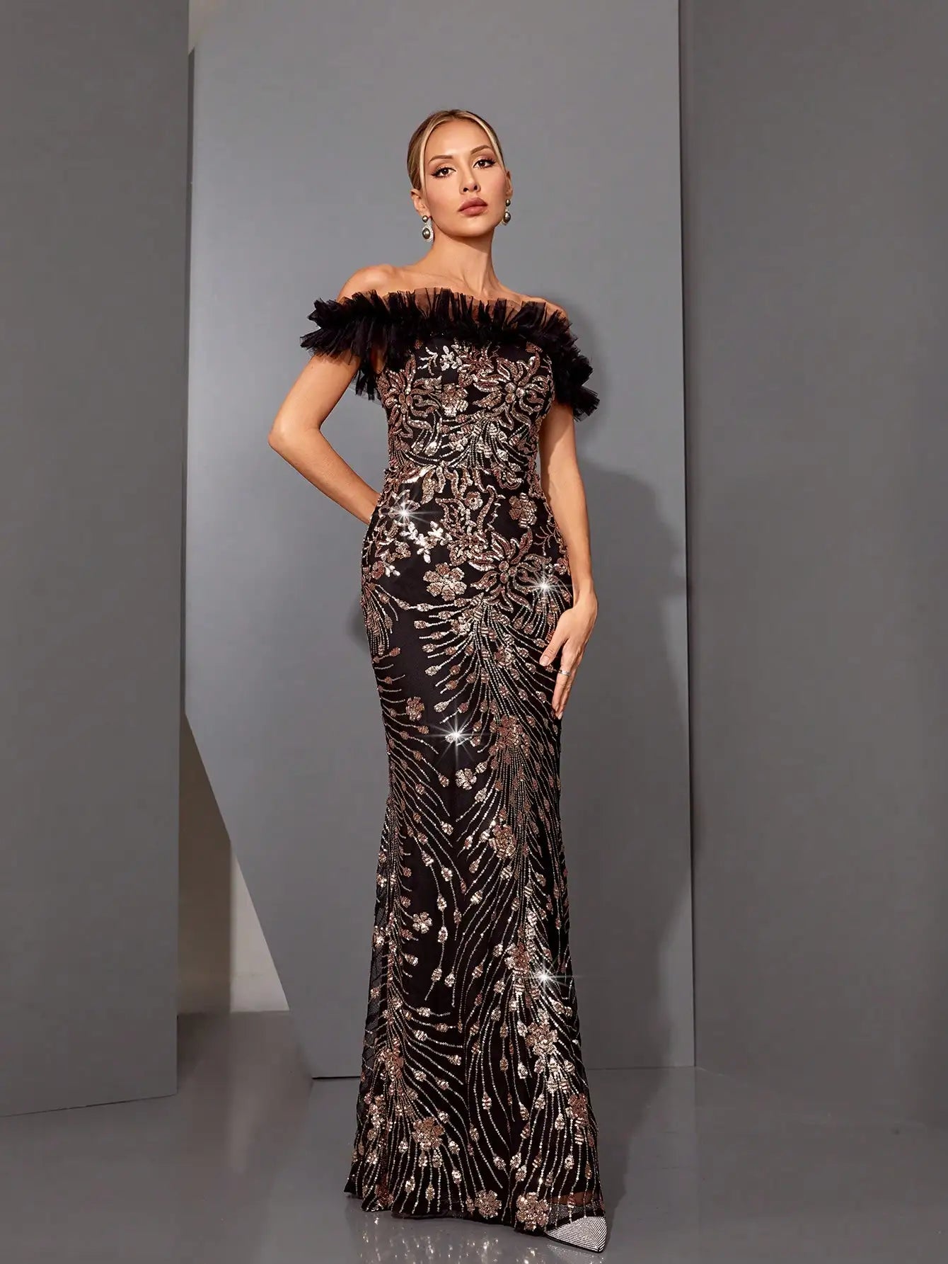 Close-up of sequin embroidery and tulle ruffle on off-shoulder neckline

