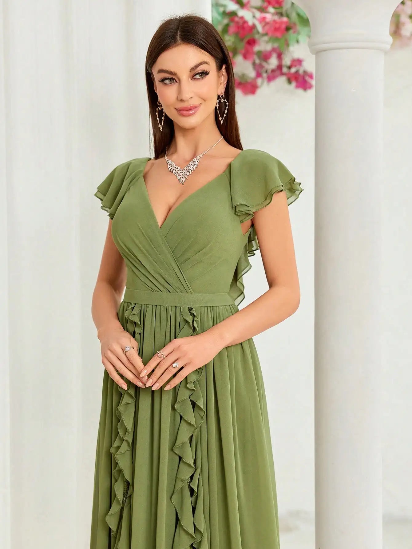 Back view of flowy green chiffon dress with zipper closure
