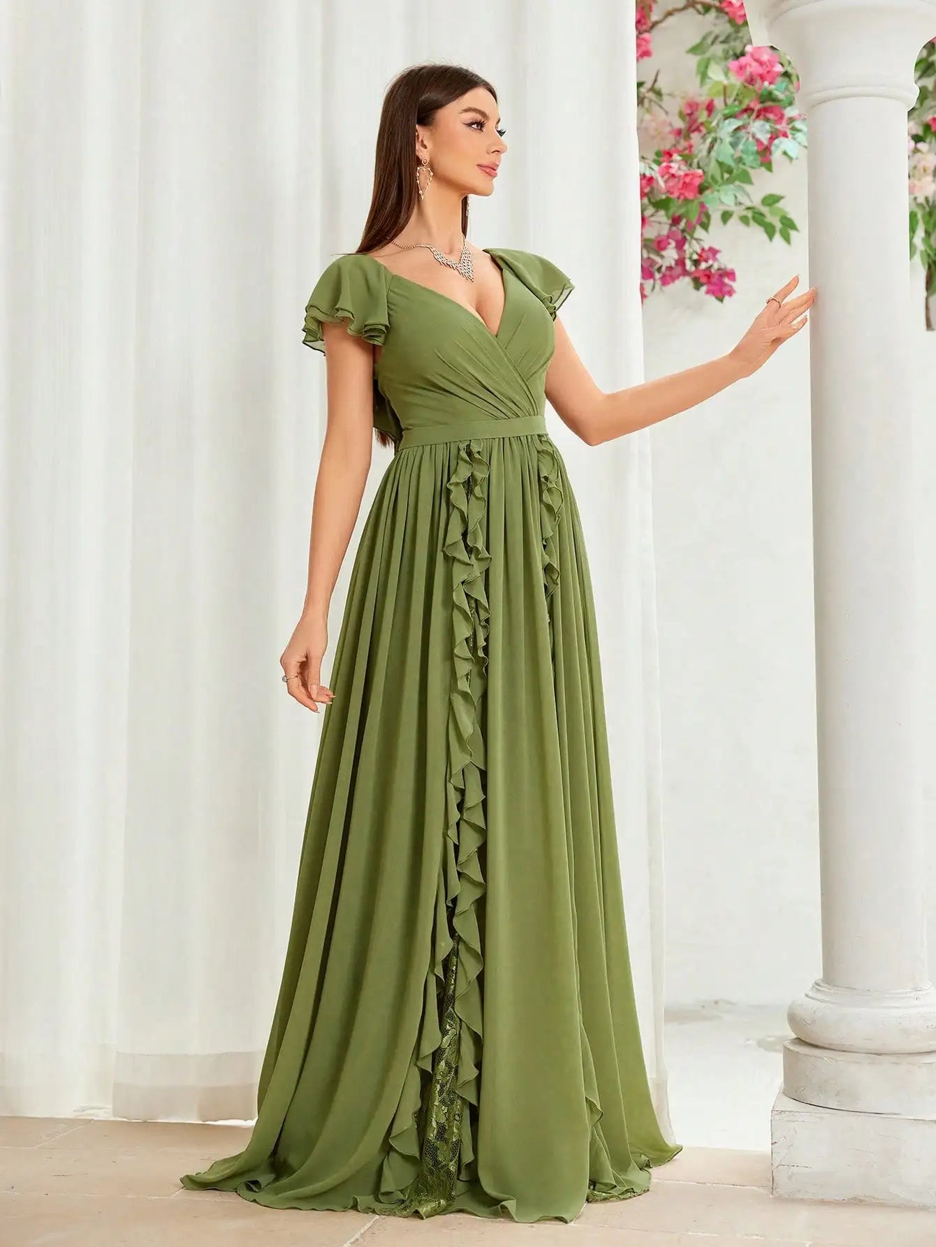 Flat lay of green flutter sleeve gown, perfect for weddings and events

