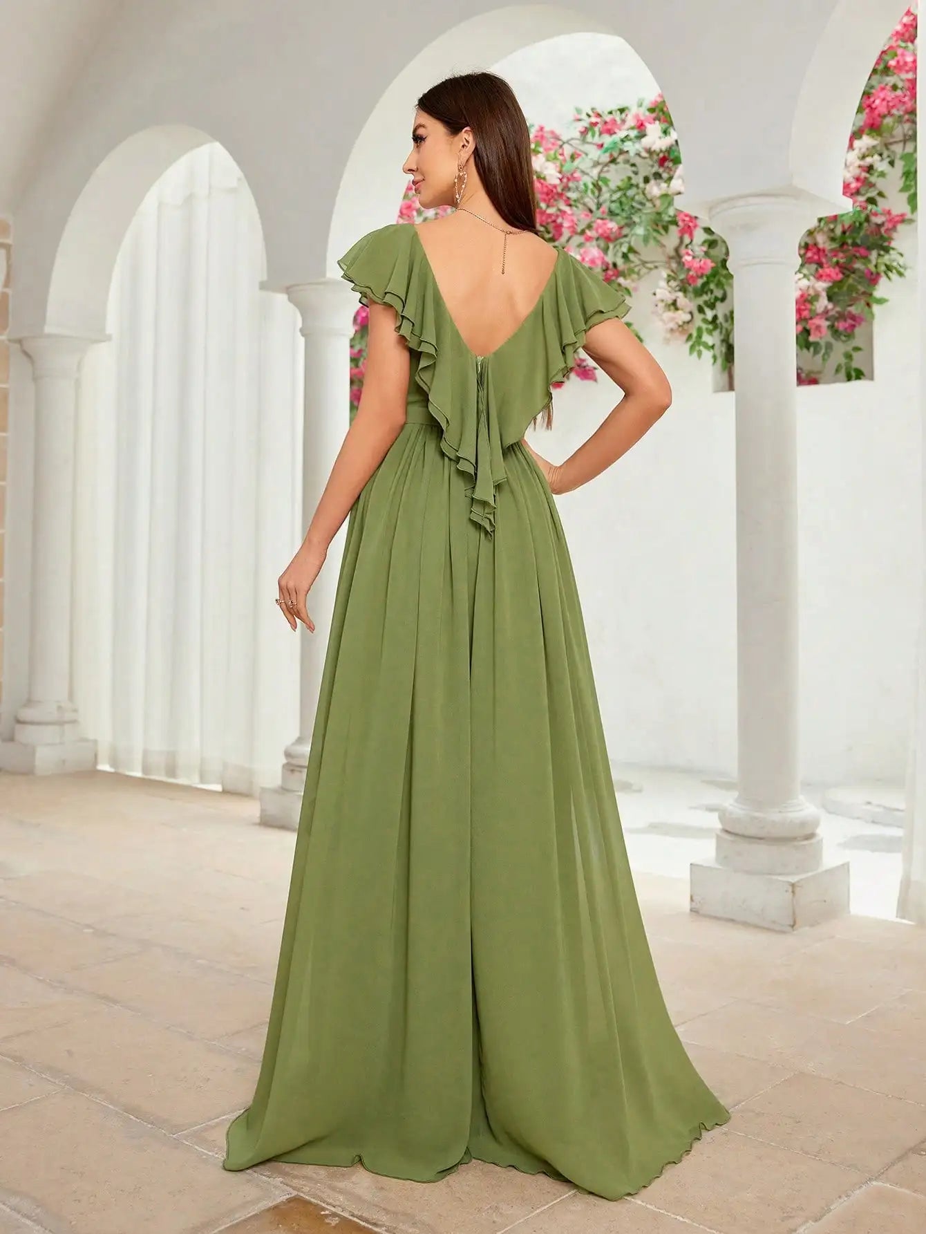 Side angle showing ruffle trim and drape of olive green evening gown

