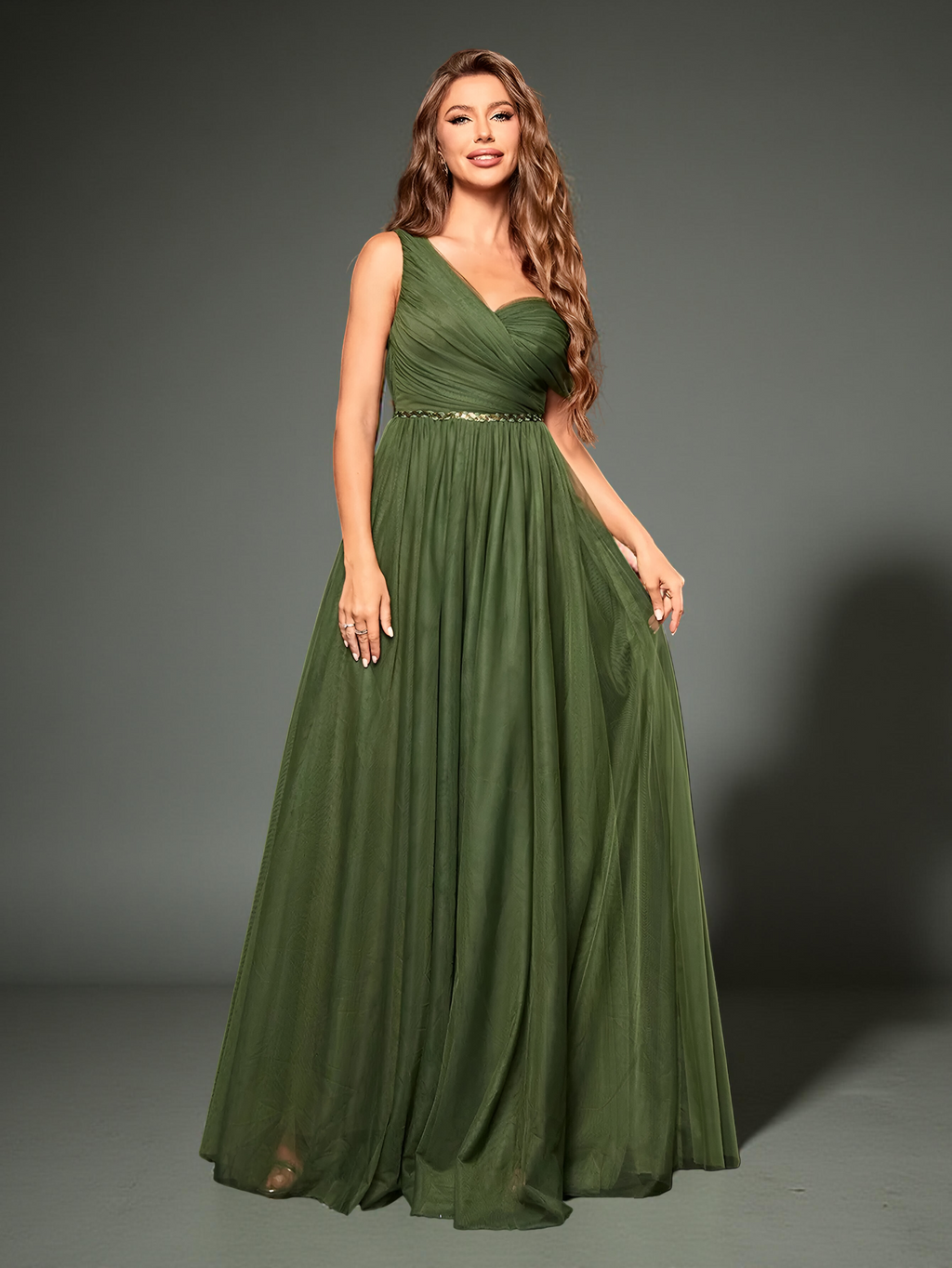 Model standing in olive green gown showing fabric flow