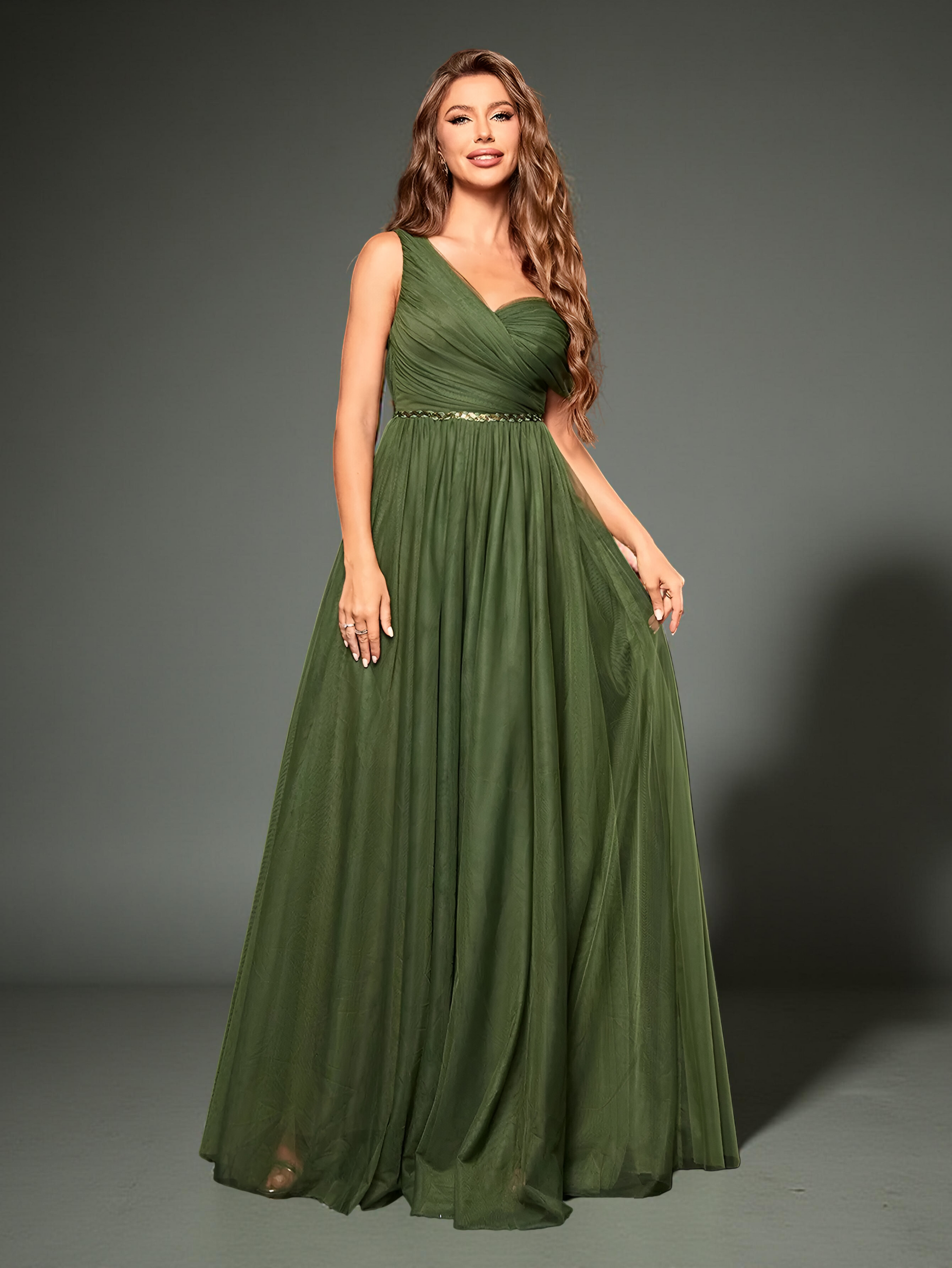 Model standing in olive green gown showing fabric flow