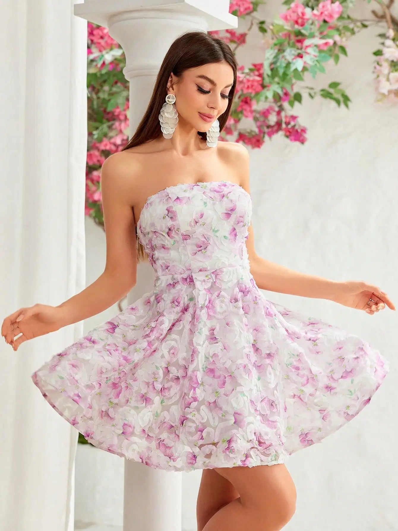 Model walking in floral pink mini dress at a spring event
